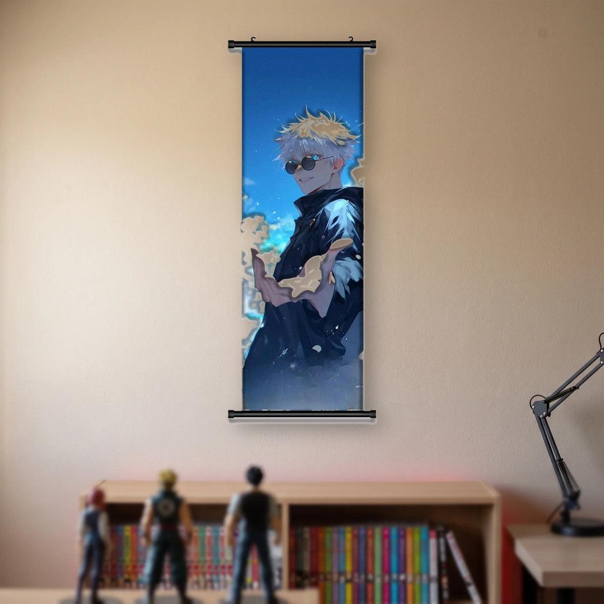 Kakémono Jujutsu Kaisen Satoru Gojo en lunettes rondes, la main tendue devant un ciel bleu, suspendu au mur beige d'une chambre au-dessus d'une étagère de tomes de manga et de figurines