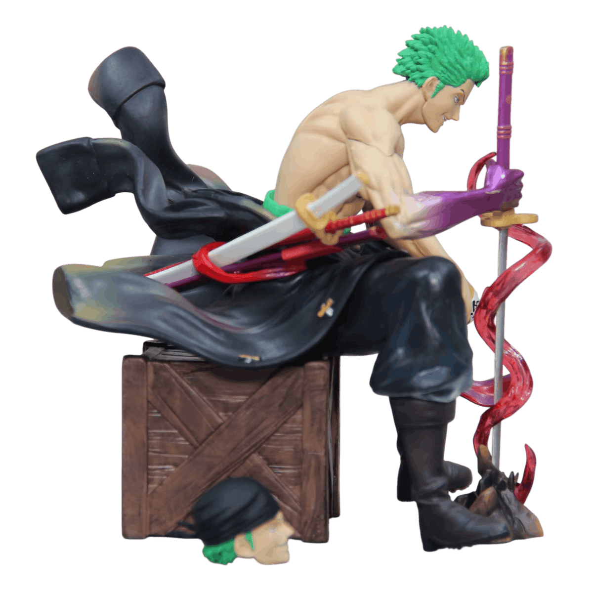 Figurine Zoro One Piece de profil : manteau sombre descendu à la taille, fourreaux rouge et violet et sabre blanc, seconde tête au bandana noir posée au sol